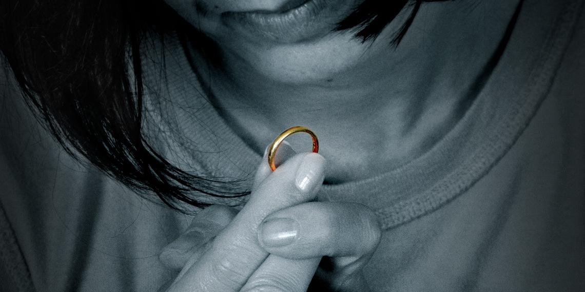 a woman looking at a ring