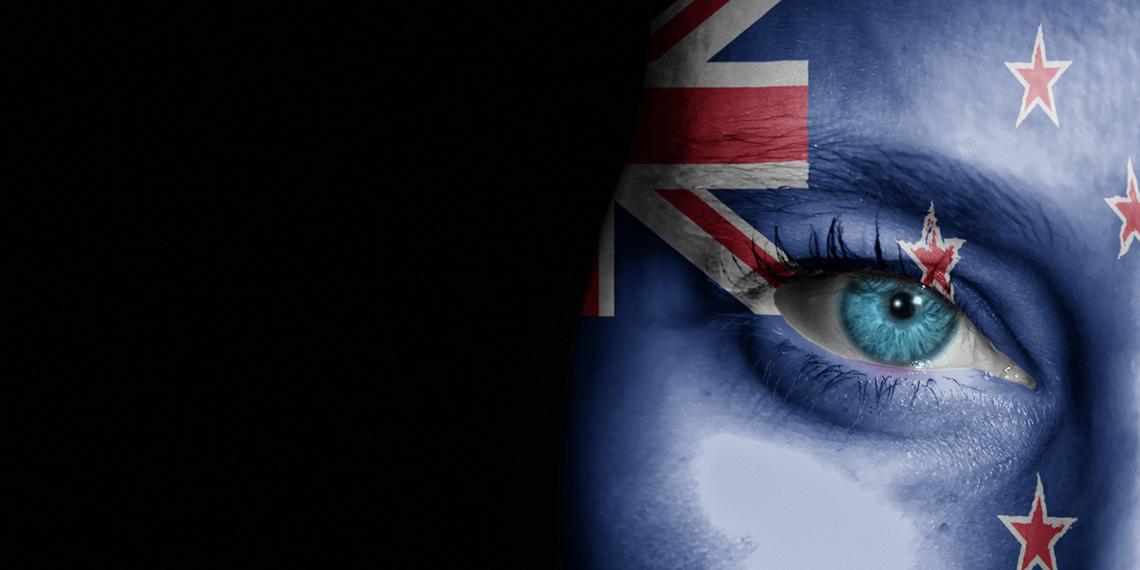 a woman with nz flag painted on face