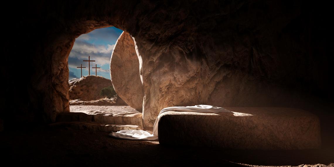 The empty tomb with three crosses in the background