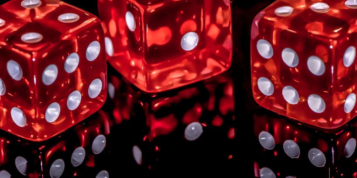 Three dice on a shiny surface