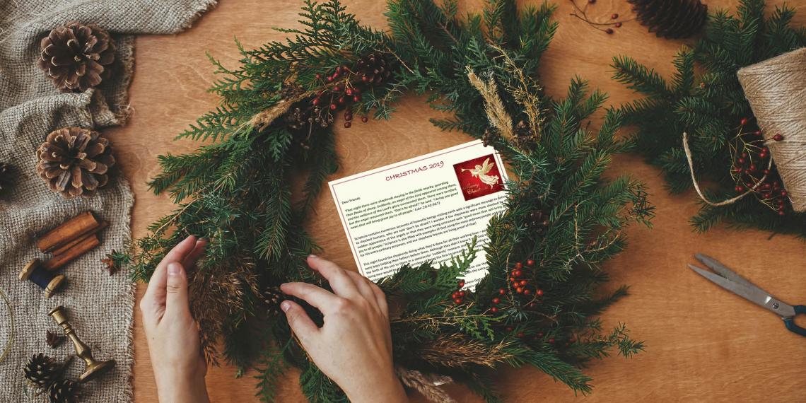 Christmas letter behind a wreath