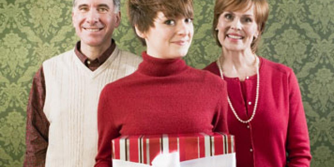 Woman holiding a present in front of parents