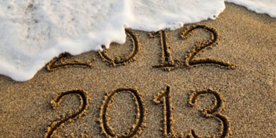 2012 and 2013 written in sand on beach