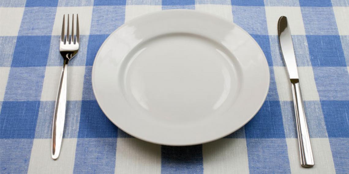 a dinner plate with knife and fork
