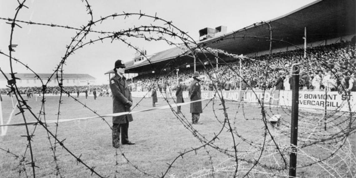 Police stand watch during the Springboks vs. Southland game at Invercargill’s Rugby Park on 8 August 1981 (Photographer: Stuart Menzies / Ref: EP-Ethics-Demonstrations-1981 Springbok Tour-01 / Alexander Turnbull Library, Wellington, New Zealand)
