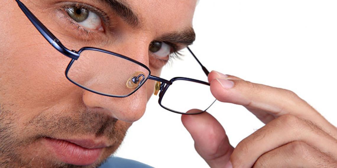 a man peering over his spectacles