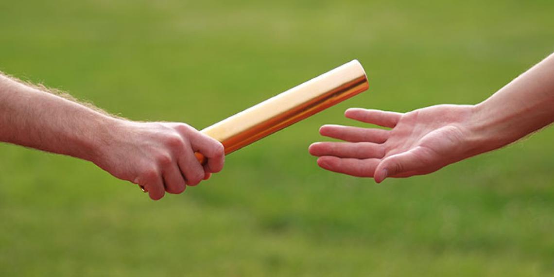 two hands holding a baton