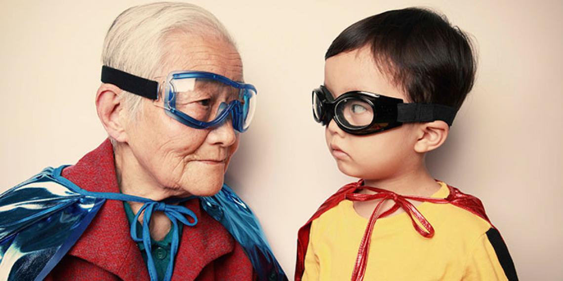 an old lady and young child dressed in superhero outfits