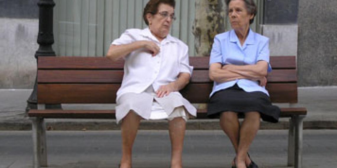 Two elderly ladies sitting on a bench