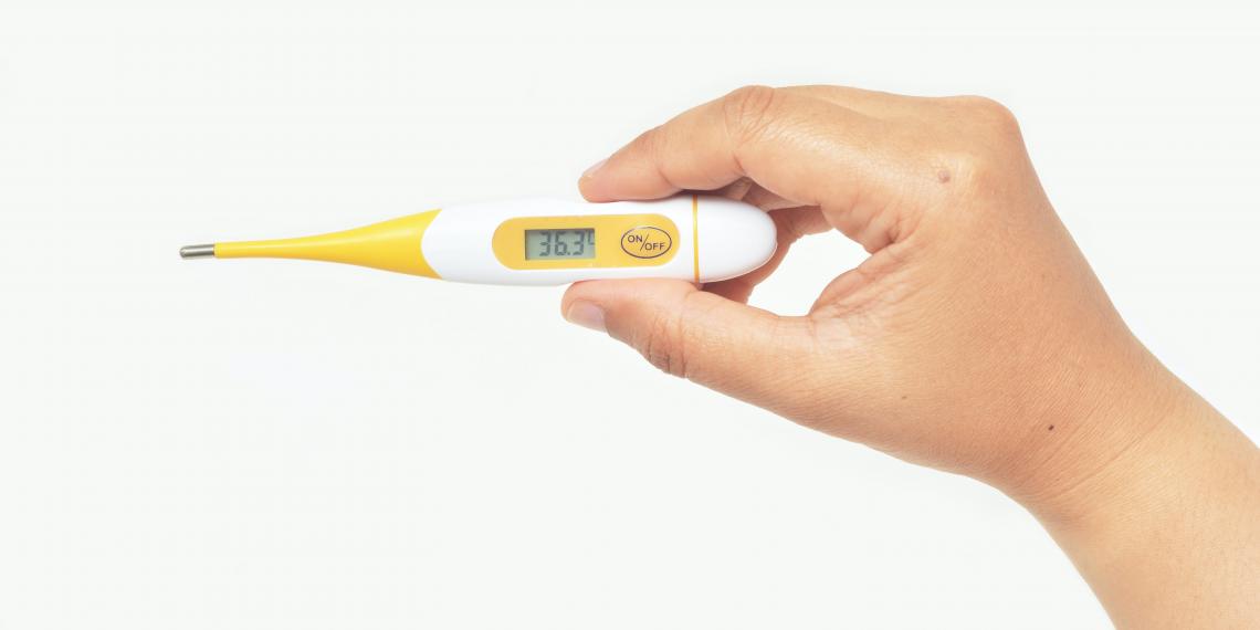 Hand holding thermometer