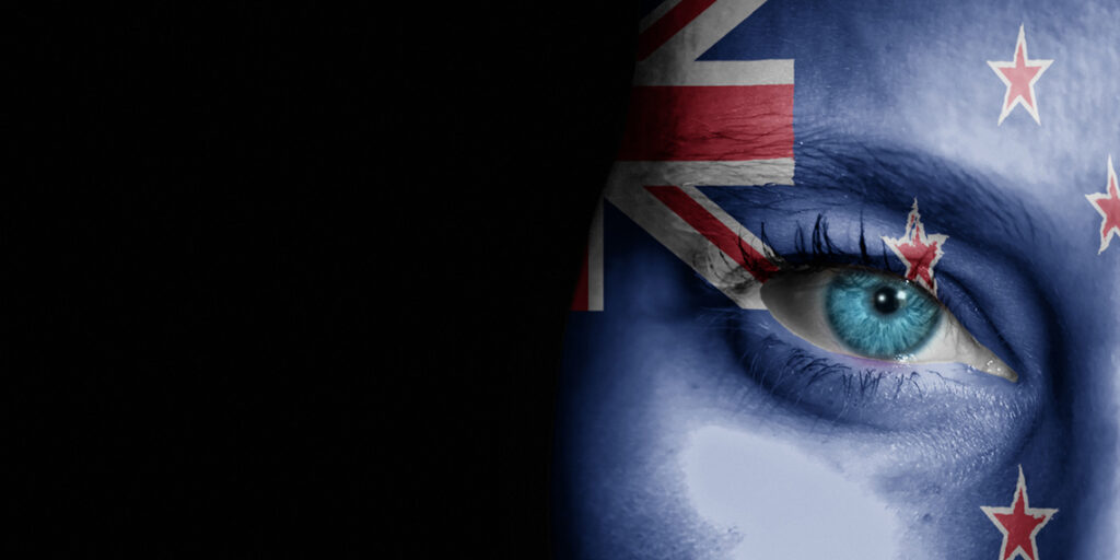 a woman with nz flag painted on face